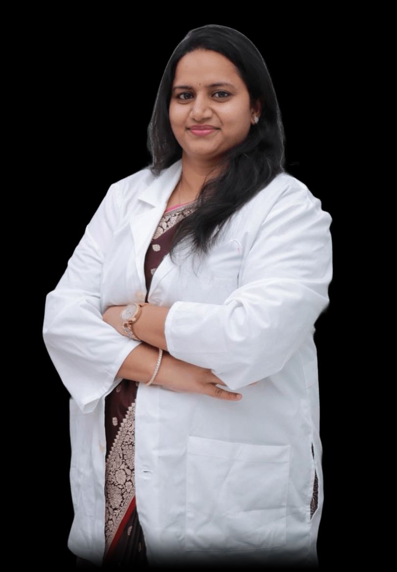 Dr. Palaparthi Lalitha Devi, standing, in a white coat
